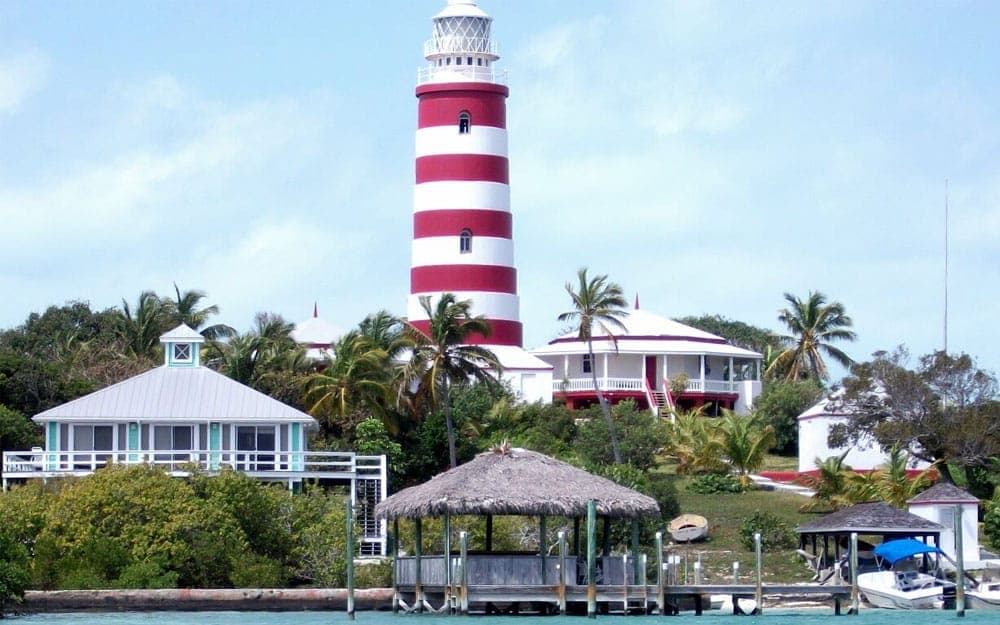 The iconic candy-striped Hope Town lighthouse above the harbour and marina