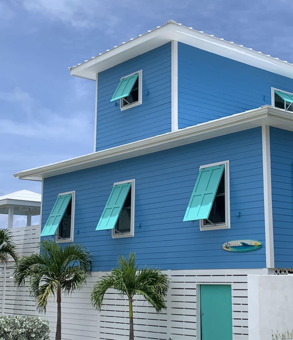 The front of the Catch A Wave home framed by tropical greenery