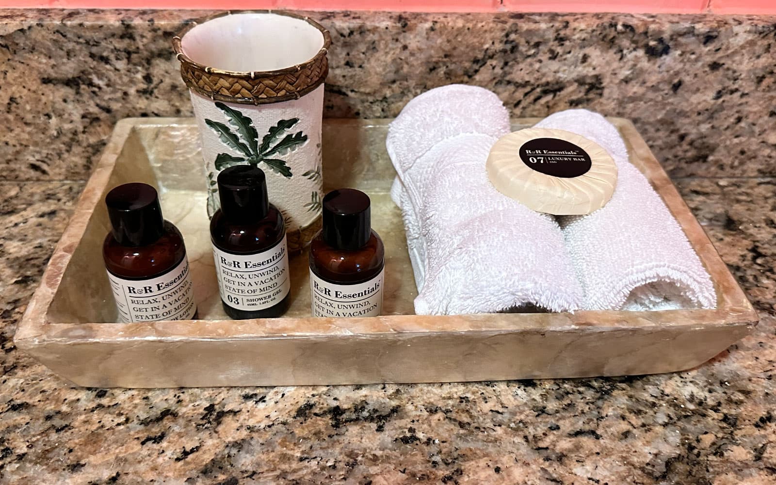 Walk-in glass-tiled shower and toiletries in the master bath