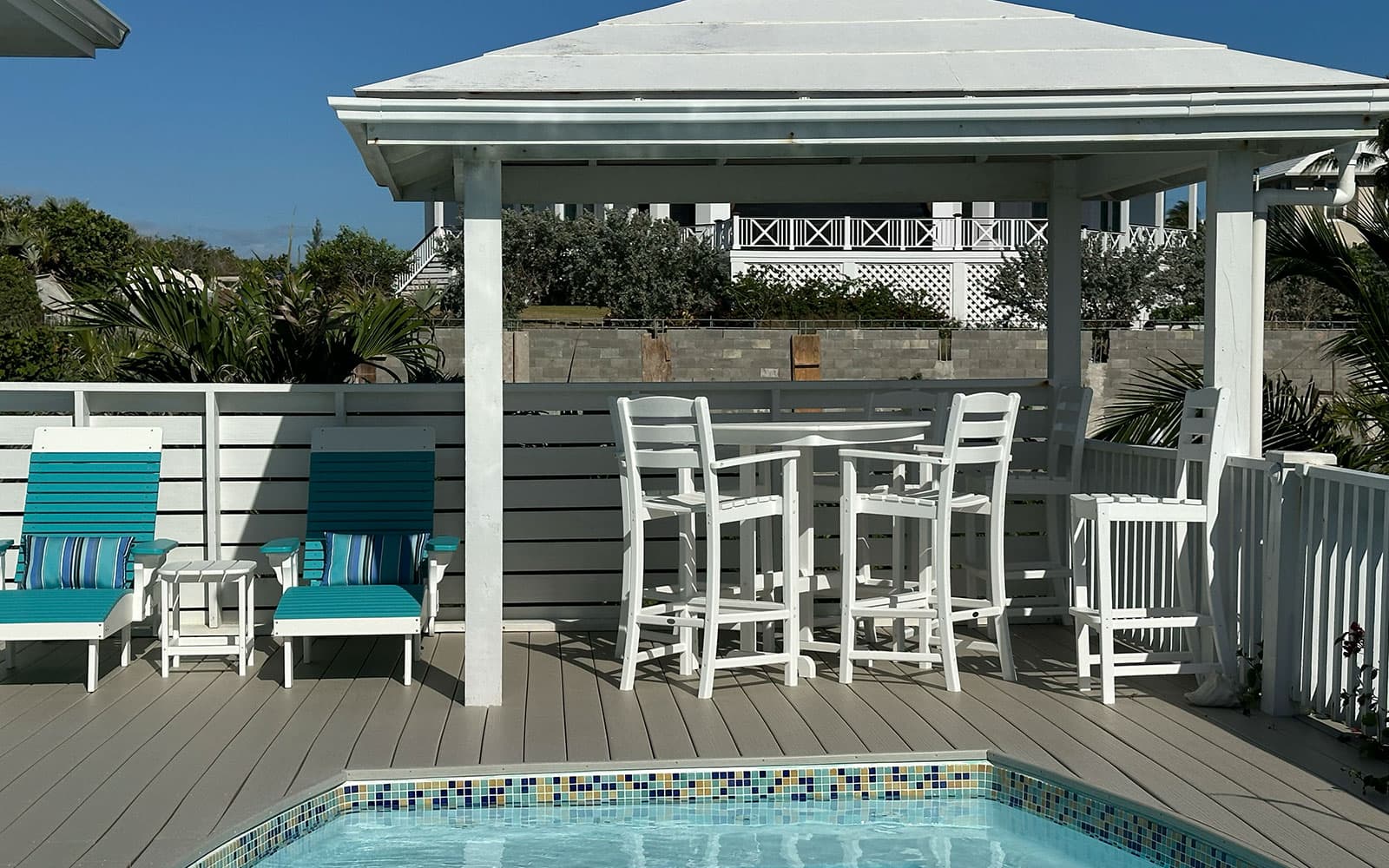 Poolside seating area overlooking the water