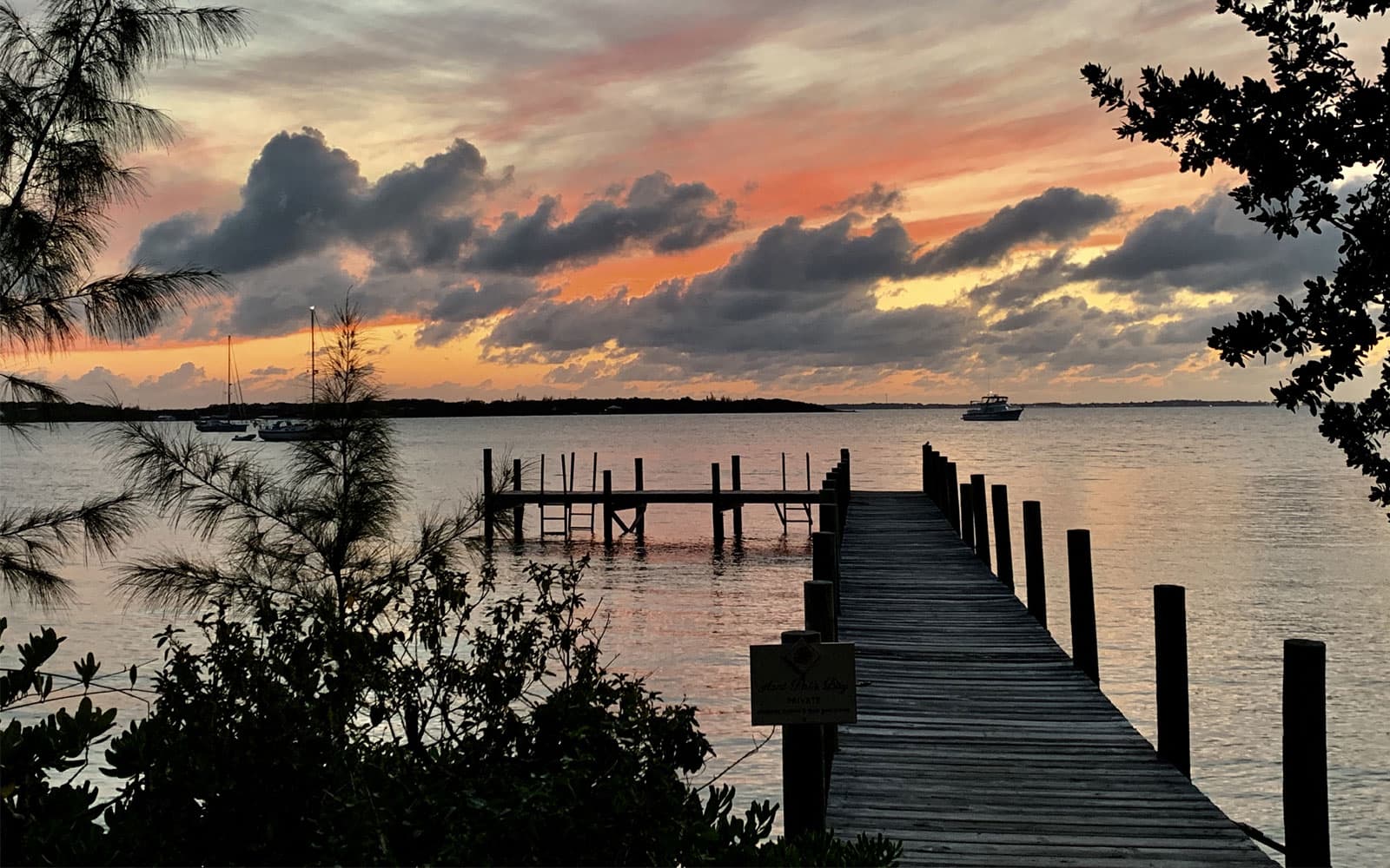 Sunset over the dock and calm water near Catch A Wave