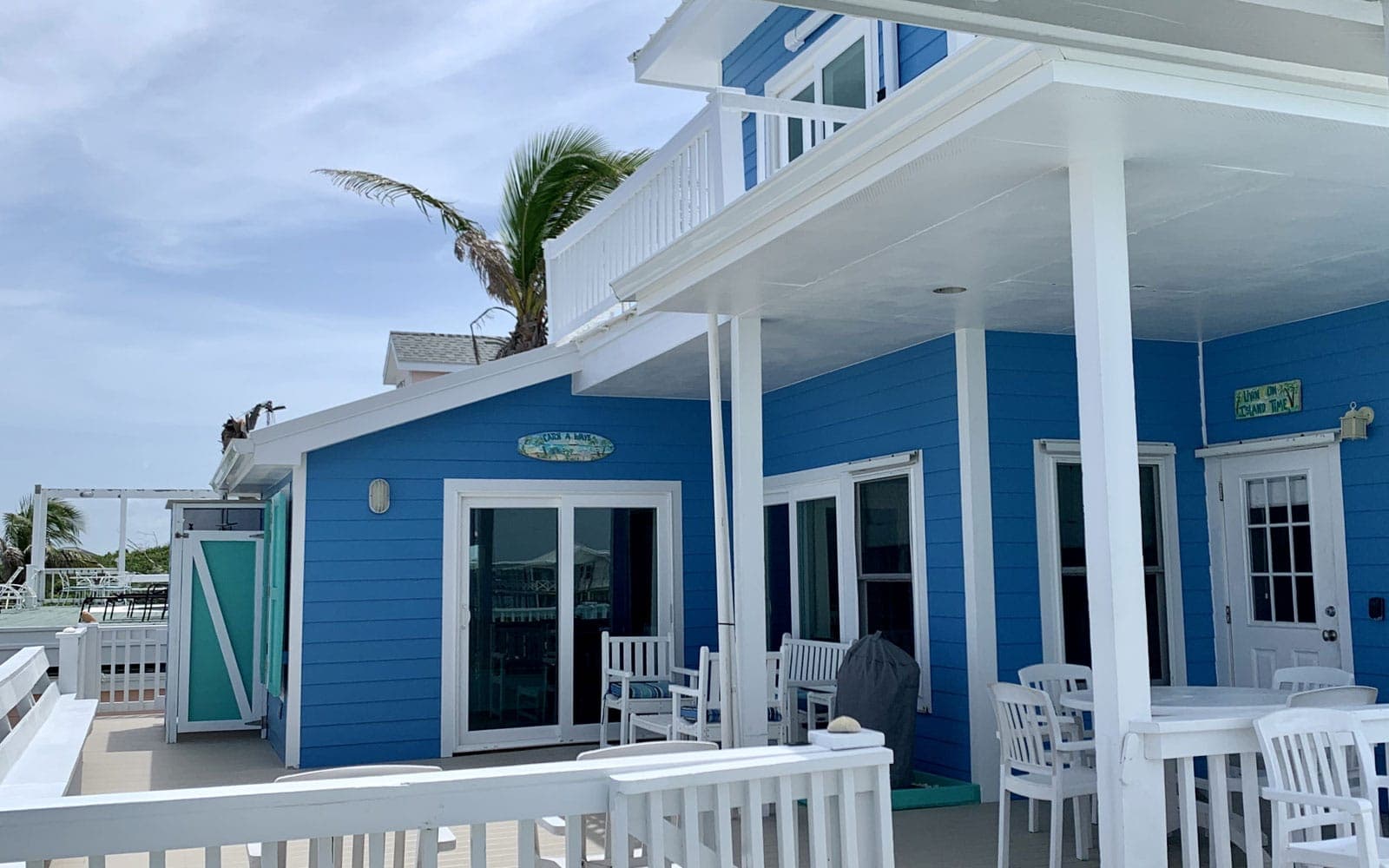 Covered sun deck with dining and lounge seating